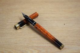 A Sheaffer Targa 1035 converter fill fountain pen in Laque Amber Ronce having Sheaffer USA 585 14K