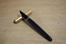 A Parker 51 aerometric fill fountain pen in black with rolled gold cap. Dents to cap
