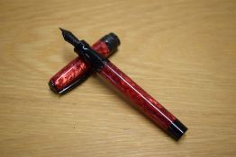 A boxed Pineider La Grand Bellezza converter fill fountain pen in Rocco Red with black trim having