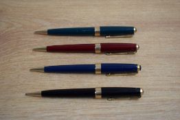 Four Parker 17 Super Duofold propelling pencils in black, red, blue, and green.