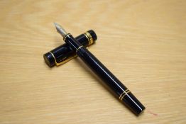A Parker Duofold International cartridge fill fountain pen in black with gold trim having Parker 18K