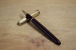 A Parker La Plume Lamine aerometric fill fountain pen in burgundy with rolled gold cap having Parker