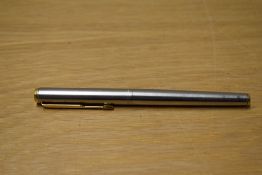 A Parker Arrow aerometric fountain pen in brushed steel with gold trim.