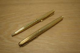 A Parker 75 converter fill fountain pen and ballpoint pen set in gold plated Perle design having