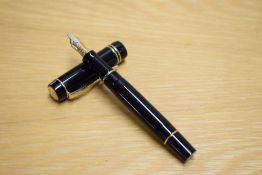 A Parker Duofold Demi cartridge fill fountain pen in black with gold trim having Parker 18K 750 nib