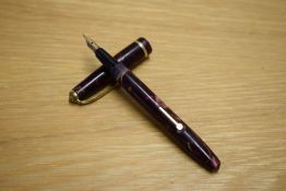 A Conway Stewart Dinkie 560 lever fill fountain pen in rose and black marble having Conway 14ct gold