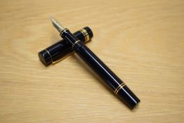 A Parker Duofold Centennial converter fill fountain pen in black with gold trim having Parker 18K