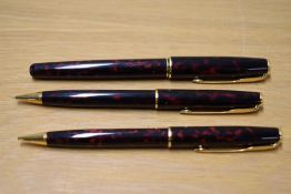 A Parker Sonnet converter fill fountain pen and two propelling pencils in Laque Firedance having
