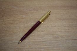 A Parker 45 ballpoint pen in red with gold reeded cap