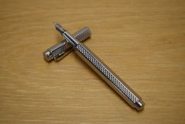 A Caran d'Ache Ecridor Cubrik converter fill fountain pen with guilloche design palladium plated