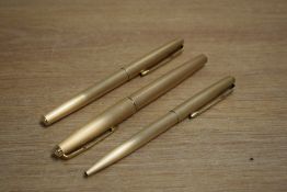 A Parker 61 Cirrus fountain pen, ballpoint pen and roller ball pen in brushed rolled gold (ballpoint
