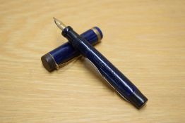 A Parker Duofold Junior Lucky Curve button fill fountain pen in dark Lapis Lazulii with a broad gold