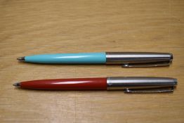 Two Parker 45 ballpoint pens one in baby blue the other terracotta