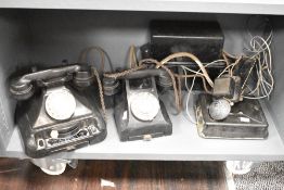 An early 20th century bakelite rotary telephone, w23cm, sold together with another telephone and