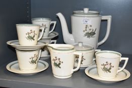 A Royal Copenhagen tea service decorated with foliage and gilt edging on an ice white ground, makers