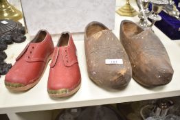 A pair of wooden clogs, L26cm, sold together with a pair of red leather childs shoes, (4)