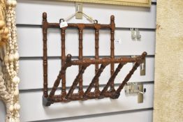 A faux bamboo style folding wall hanging magazine rack, w26cm