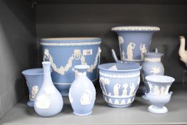 A large Wedgwood blue and white Jasperware urn with twin handles, decorated with classical motifs