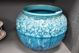 A Burmantof Faience jardinière, decorated with relief mould with band of blossoms over reserves of