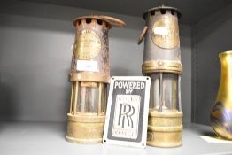 A Rolls Royce metal plaque, H12.5cm, sold together with two Eccles oil lamps, largest h25.5cm, (3)