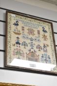 A 20th century embroidered sampler having alphabet, figures and floral motifs, h31cm x w37cm