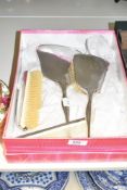 An Art Deco style white metal dressing table set, comprising of hair brush, mirror, comb and further