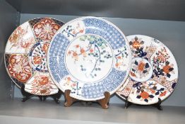 A Japanese porcelain charger decorated with tree in full blossom and blue and white geometrical