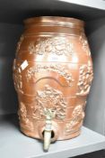 A 19th century salt glazed stoneware wine barrel, having metal tap and decorated with British coat