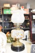 An early 20th century brass oil lamp having frosted floral glass shade, h46cm