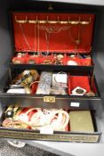 A faux leather three tier jewellery box, containing a large collection of costume jewellery