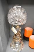 A cut glass crystal mushroom lamp having geometrical patterns and raised on a circular footed