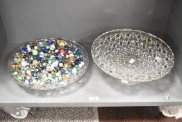 A lead crystal glass bowl having geometrical patterns and raised on a circular footed base, w33cm