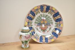 A Royal Tichelear ceramic charger decorated with multicolour foliage on a white ground, pattern 148,