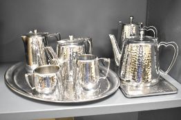 A Olde Hall stainless steel tea service, having hammered effect patterns and shaped handles, to