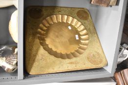 A large middle eastern charger/tray having scalloped centre and engraved floral patterns, w50cm