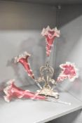 A Victorian cranberry glass epergne, having 3 stems decorated with twisted glass decoration,