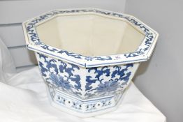 A large blue and white pot of hexagonal form, decorated with floral patterns and pierced base,