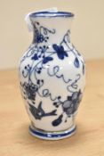 A blue and white ceramic vase, decorated with birds, butterflies and floral patterns, cross sword