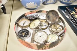 A box containing various vintage pocket compasses and map readers, ( 10 )