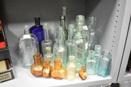 A vintage sulpholine cobalt blue glass bottle in rectangular form, impressed mark reading 'NOT TO BE