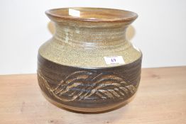 A 20th century studio pottery vase of baluster form, decorated with geometrical patterns on a