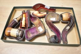 A19th century tobacco pipe of typical form, having horn mouth piece and silver lidded mount and