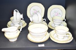 A fine bone china tea service, decorated with gilt edges and floral patterns on a yellow ground, (