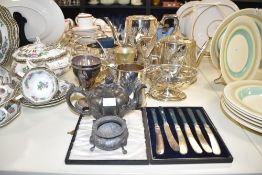 A silver plated tea pot, decorated with foliage having shaped spout and handle, h20cm, sold together