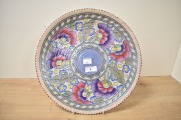 A Charlotte Rhead for Crown Ducal ceramic charger, hand painted with floral patterns and signed to