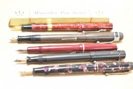 Five fountain pens. A boxed Waverley glass nib lever fill in red, a Selsdon lever fill in BHR, a