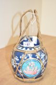 A vintage Chinese blue and white ginger jar decorated with prunus, bound in straw having
