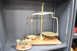 A large 'Avery' scale on wooden base with weights, h50cm, sold together with a miniature weighing