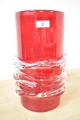 A large red glass vase of cylindrical form, decorated with clear glass swirl design, h31cm