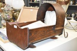 An early 20th century wooden doll's crib, L48cm